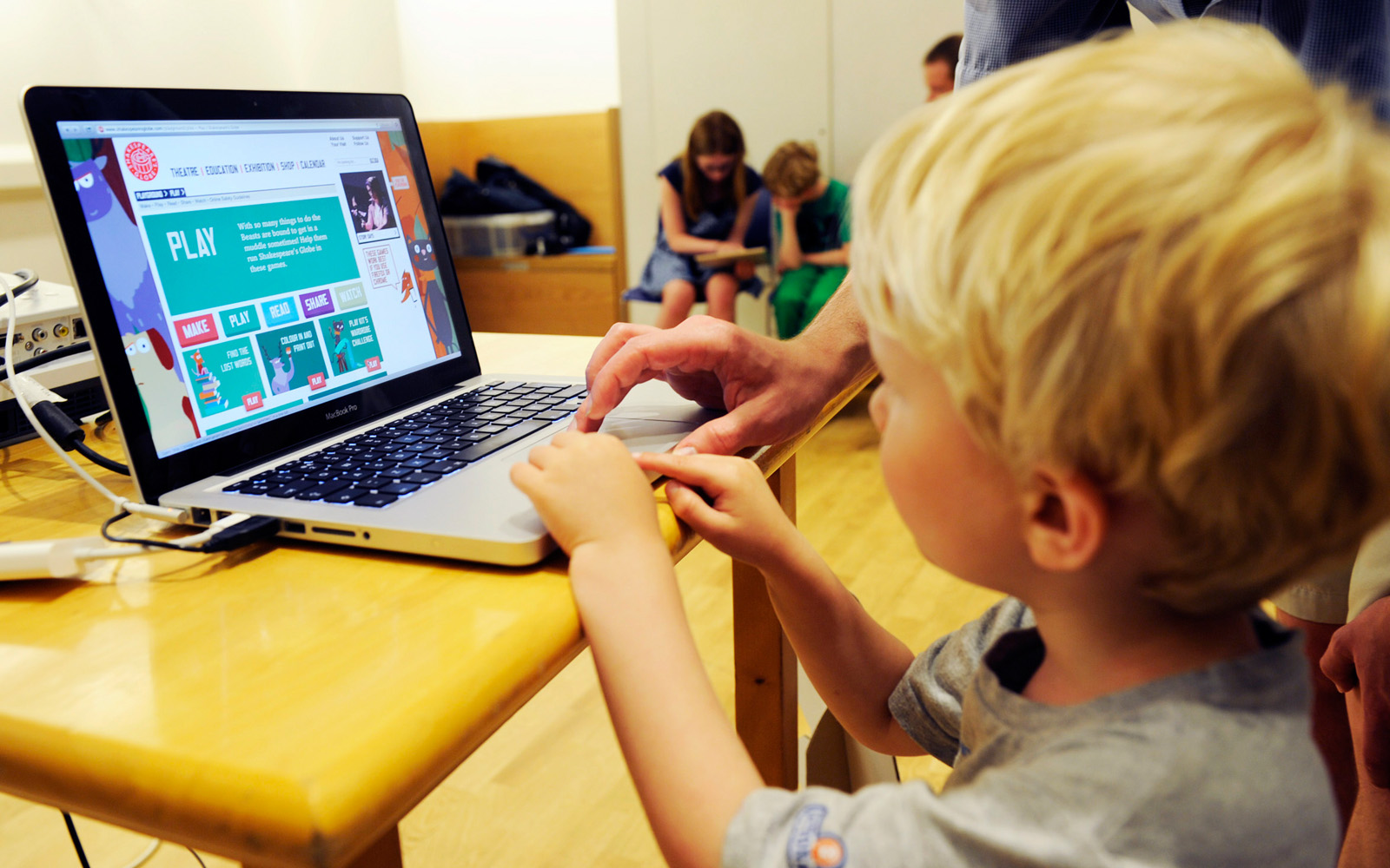 A young boy uses a laptop to browse learning resources