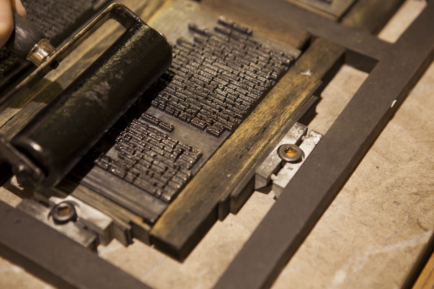 PrintPress1 An ink roller running across a template of letters