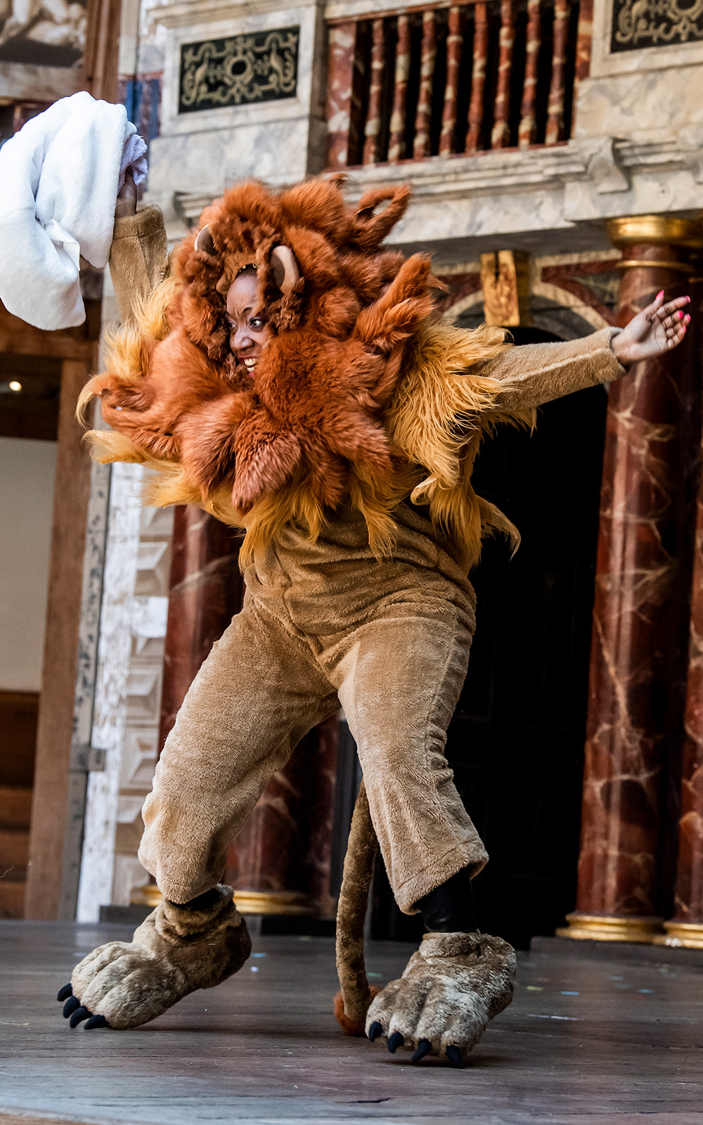 A person mid-air in a lion costume