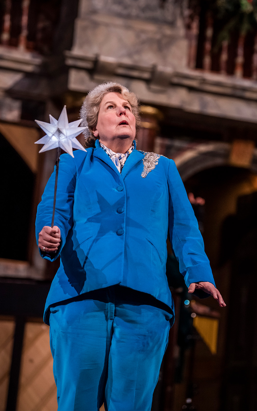 Sandi Toksvig Christmas Snow Globe Tristram Kenton A woman in a blue suit on a stage