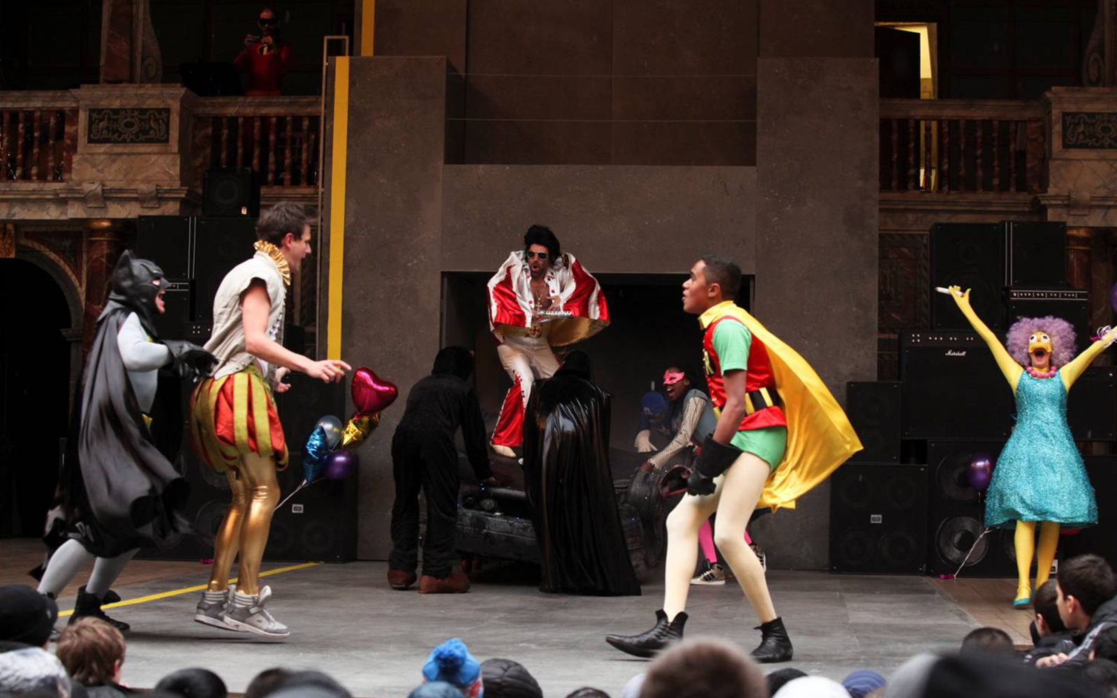 Actors on stage in fancy dress costumes are about to fight