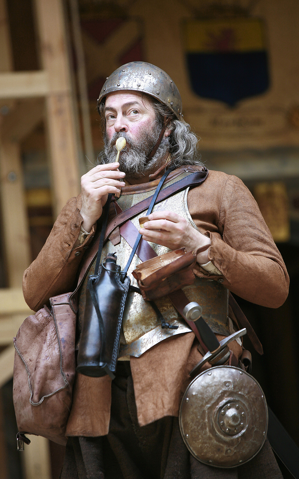 Actor on stage with a wooden spoon on there mouth