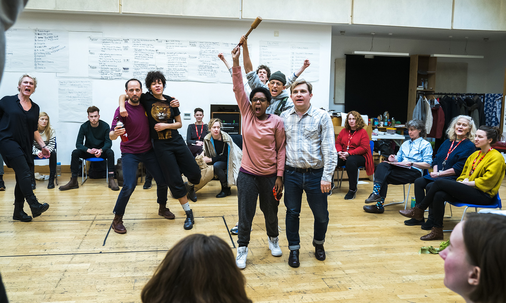 Leaphia Darko in Henry V rehearsals A rehearsal room with some actors punching in the air, one is being lifted, other sit around them in chairs