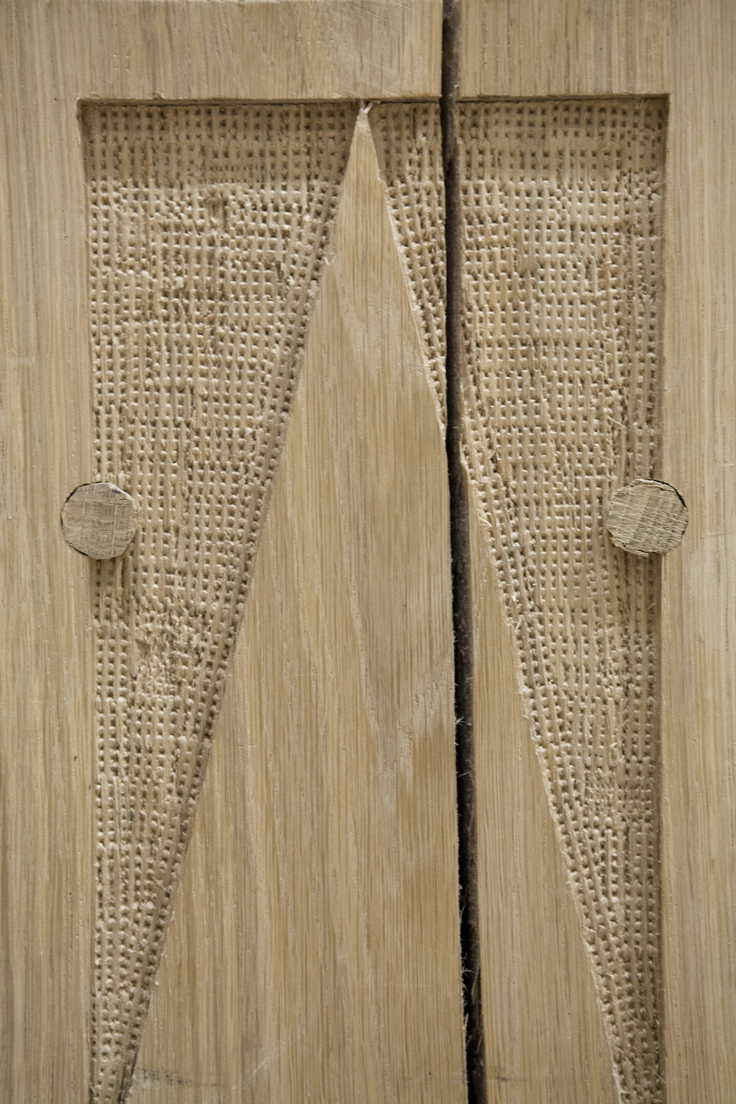 A close up of a wooden material with textured patterns carved into it