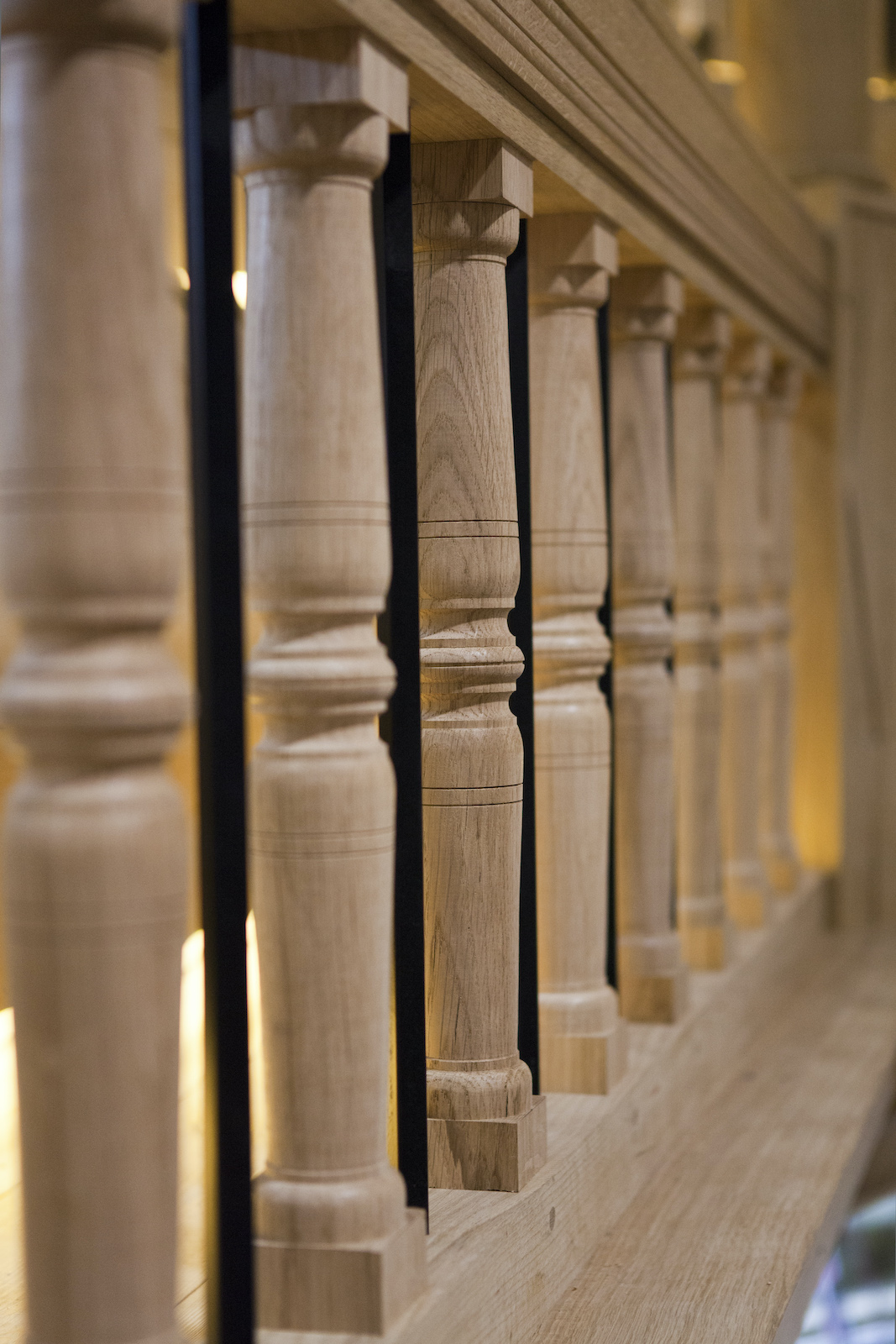 Sam Wanamaker Playhouse Pete Le May A close up of the wooden bars that line a gallery of a stage