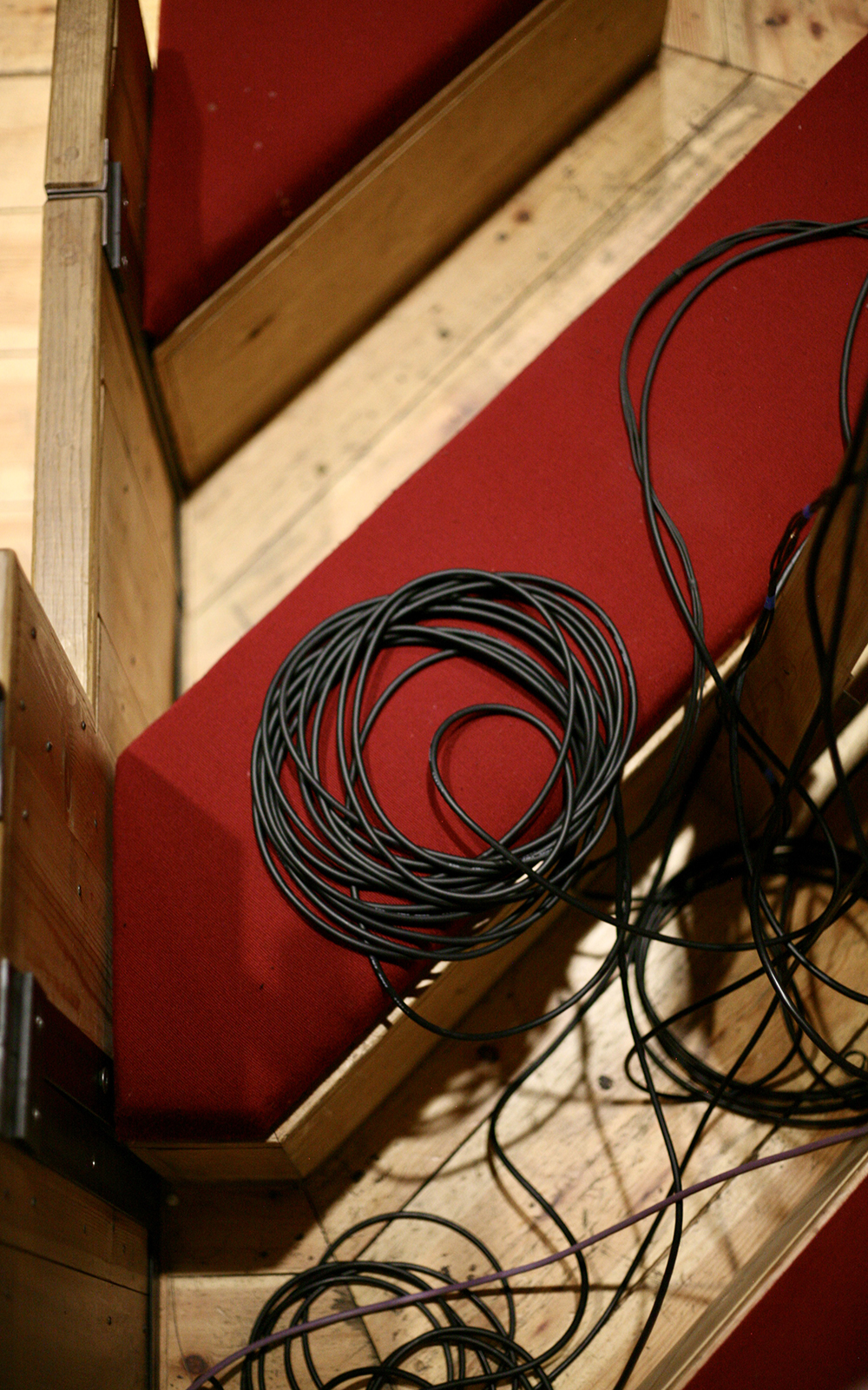 Coiled up cables resting on one of the seats in the Sam Wanamaker Playhouse