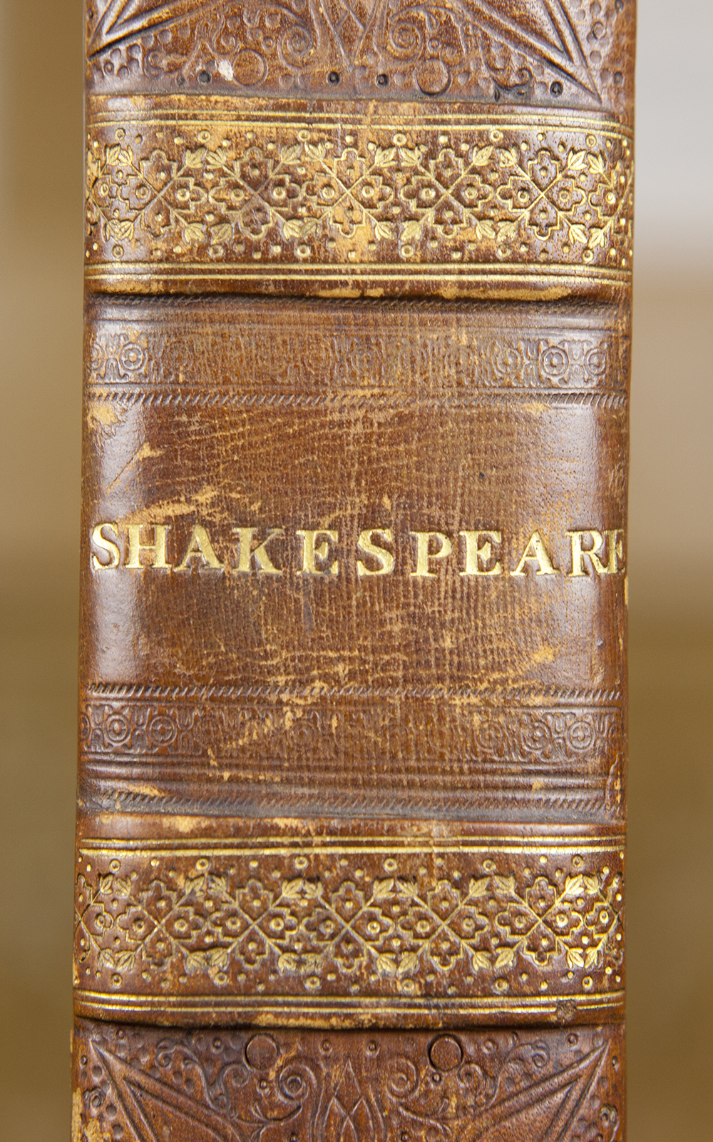 Mr. William Shakespeare's Comedies, Histories, & Tragedies, 1623 The brown spine of a book shows the word Shakespeare