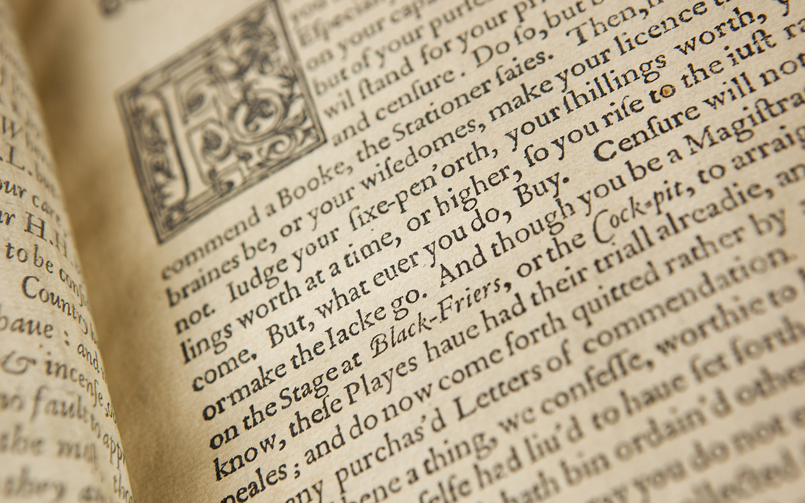 Munro First Folio Page Pete Le May An old book lies open, with a floridly illustrated first letter