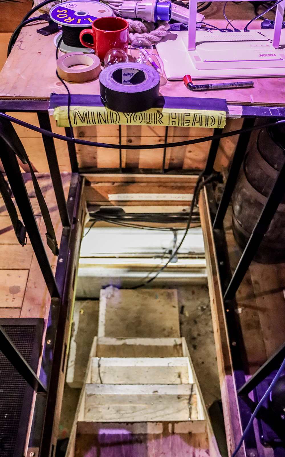 Heaven to Hell Globe Magazine Article Greg Morrison A narrow, steep staircase leads down to a basement, with a 'mind your head' sign above it
