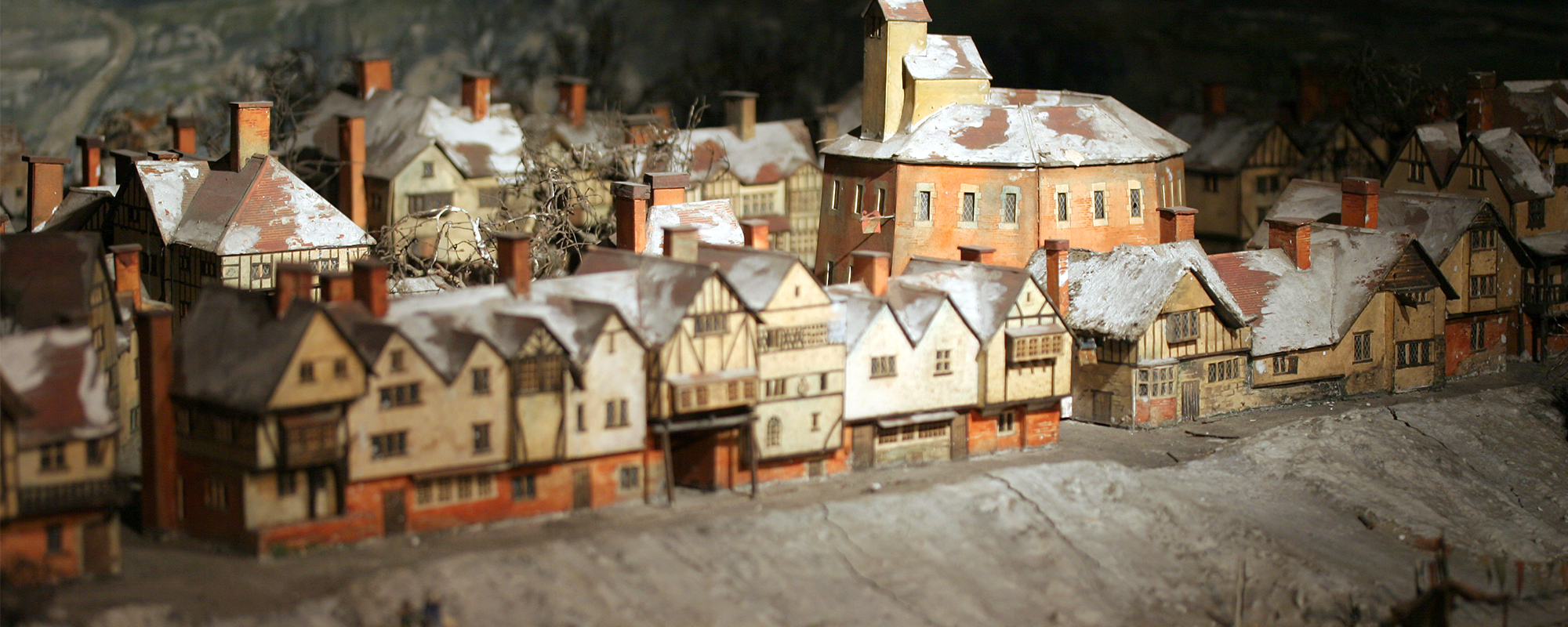 A Chirstmas Miracle Such Stuff Season 7 Episode 4 masthead A model box of a wooden circular theatre surrounded by smaller Tudor buildings, along the bank of a snowy and frozen River Thames.