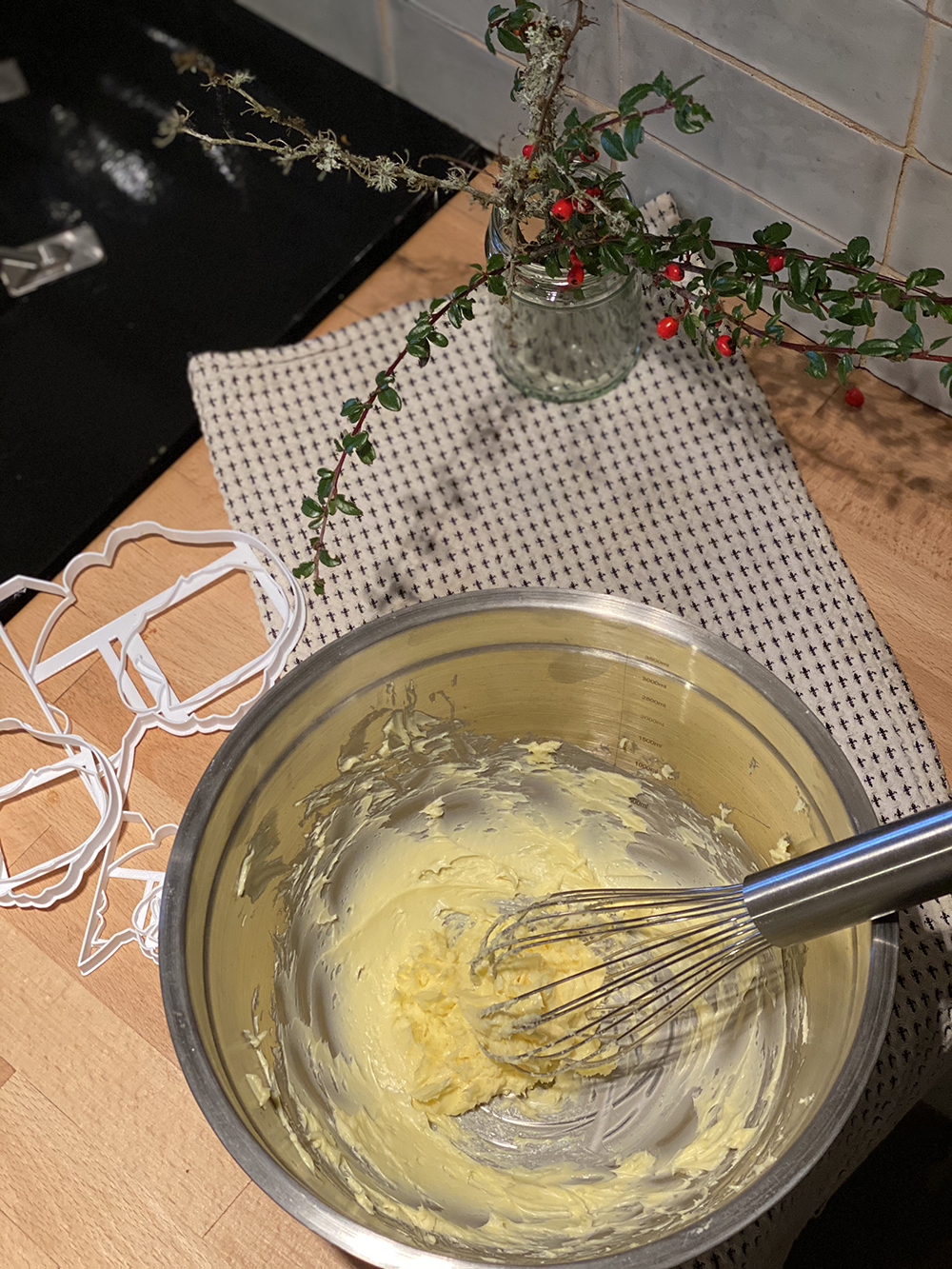 Butter is whisked in a metallic mixing bowl.