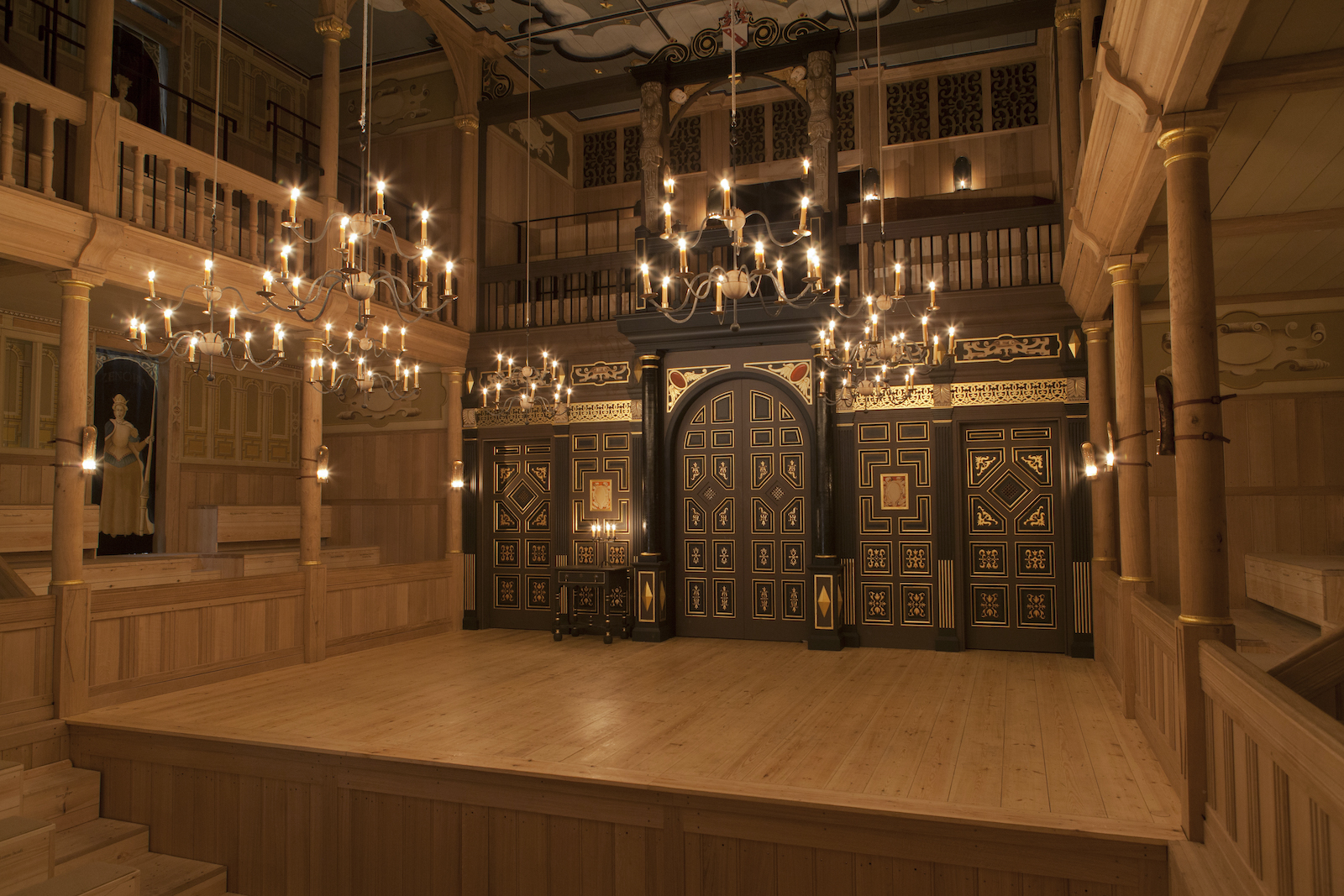 An indoor wooden playhouse lit by candles