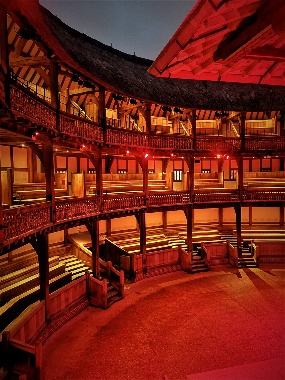 Light It In Red March 2021 Shakespeare's Globe 3 The inside galleries of the Globe Theatre are bathed in a red light.
