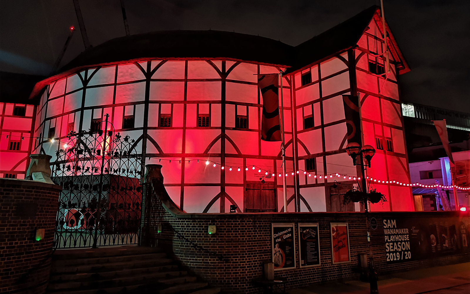 Light It In Red March 2021 Shakespeare's Globe 8 The Globe Theatre on bankside at night, lit by red light.