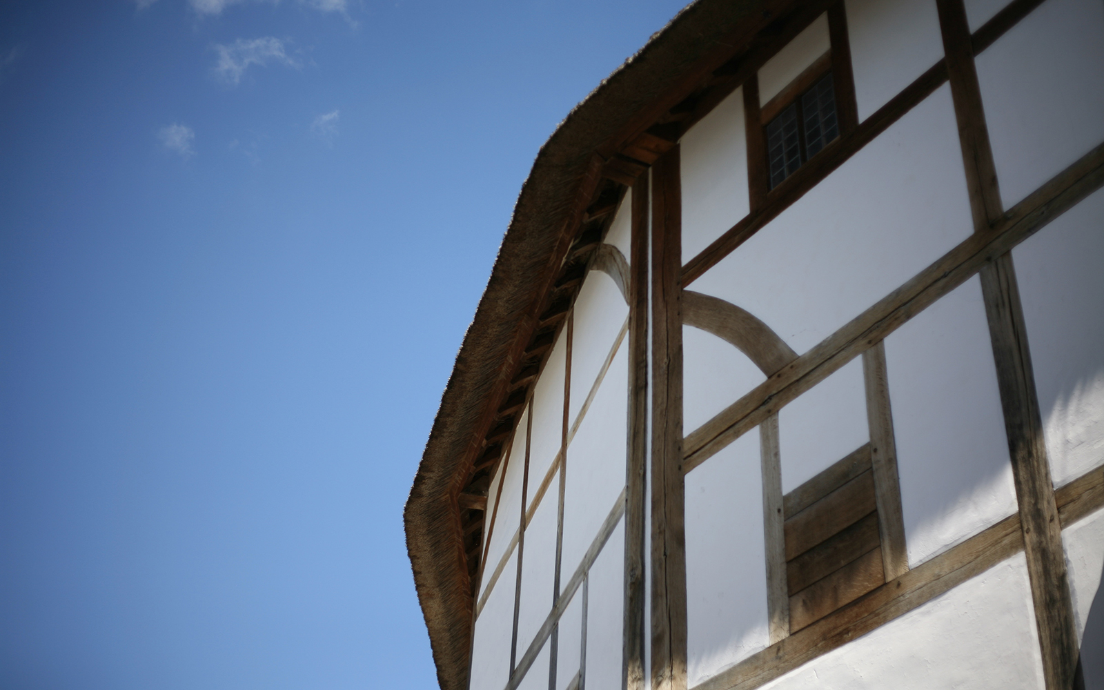 Spring Globe Theatre Reopening 2021 Card The exterior white wattle and daub timber walls of the Globe Theatre loom above, with a spring blue sky overhead