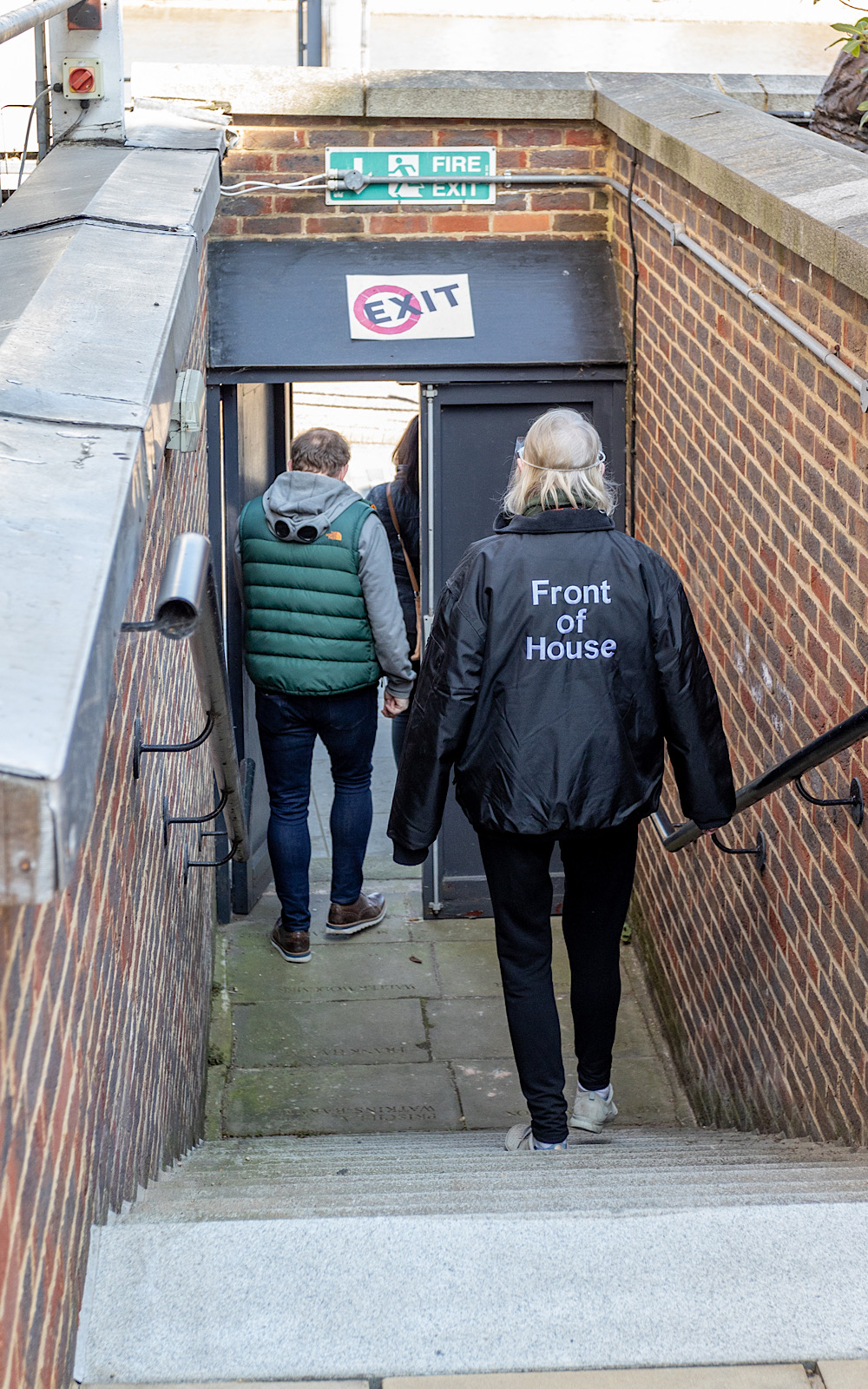 Guided Tours 2021 Pete Le May Two people walk down outdoor steps towards a sign that reads ‘exit’
