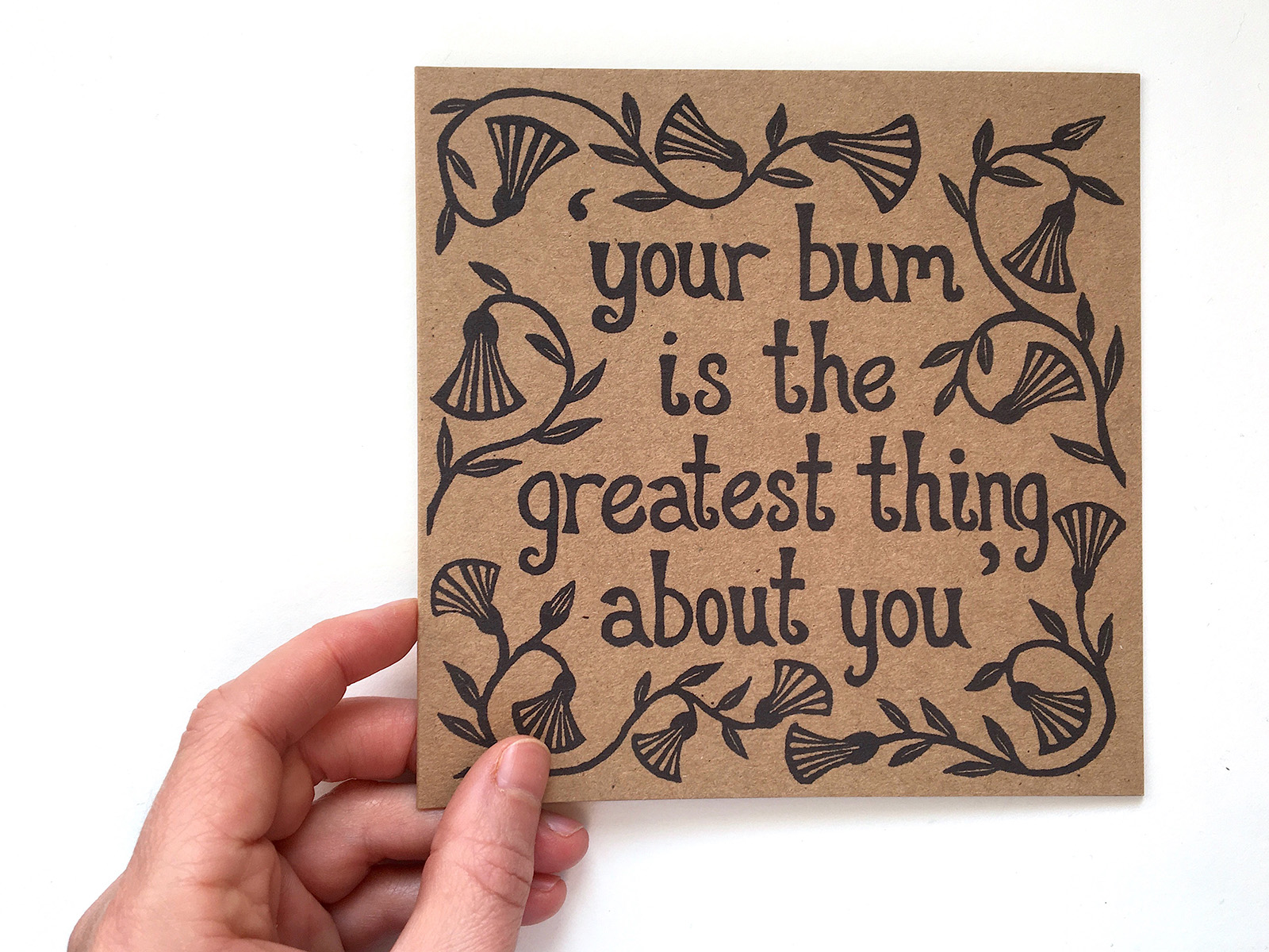 A square kraft paper greeting card with the text: Your bum is the greatest thing about you