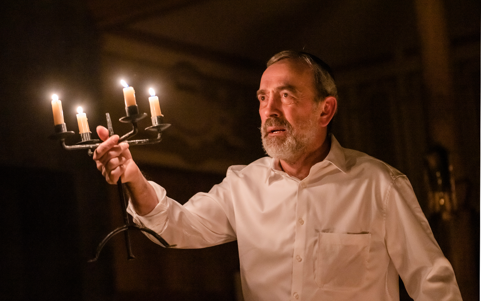 A man holding up candles
